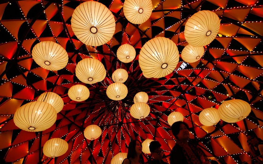 Visitors tour the illuminated decorations and lighting of small bulbs set up at popular Victoria Park to celebrate the Chinese Mid-Autumn Festival in Hong Kong Thursday, Sept. 27, 2012. Like ancient Chinese poets, Hong Kong people appreciate the beauty of the full moon in the Mid-Autumn Festival, which falls on Sunday Sept. 30 this year. (AP Photo/Kin Cheung)